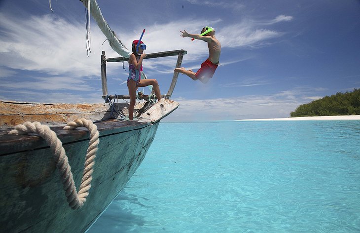 andBeyond Mnemba Island kids jumping from the boat