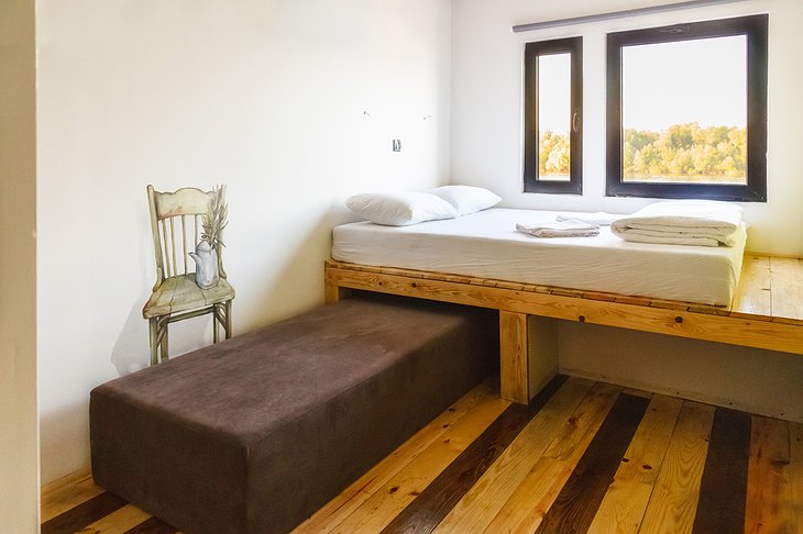 ArkaBarka Floating Hostel room with wooden platform for bed