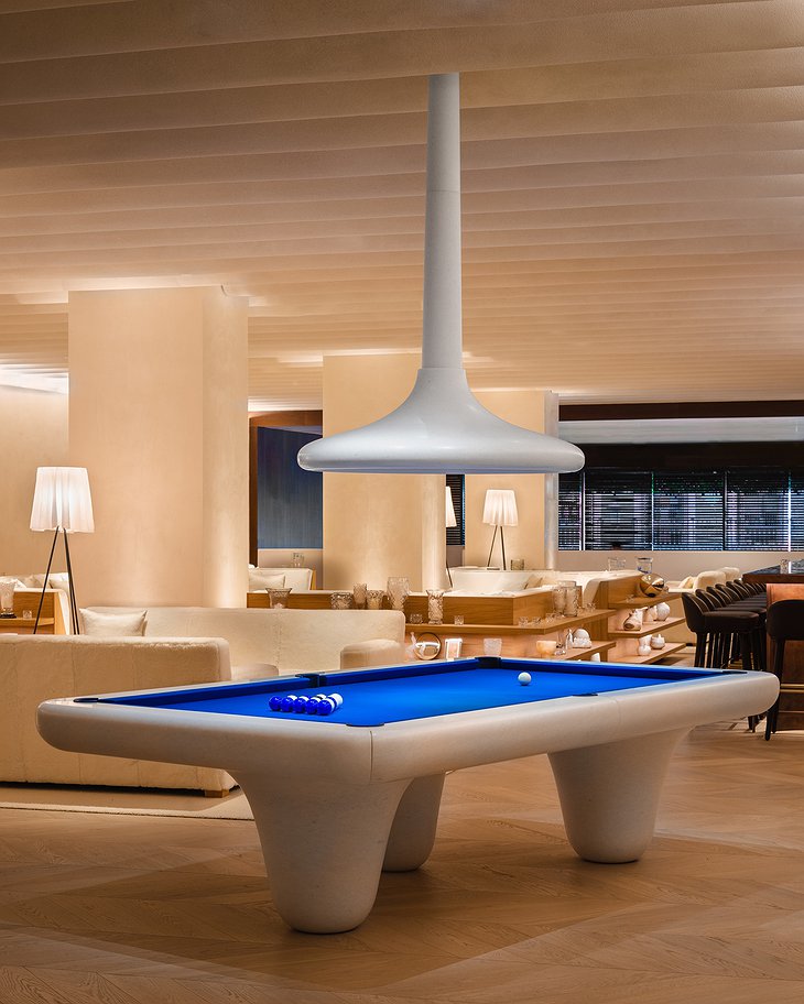 Iconic white marble pool table in the lobby of The Madrid Edition Hotel designed by Emmanuel Levet Stenne
