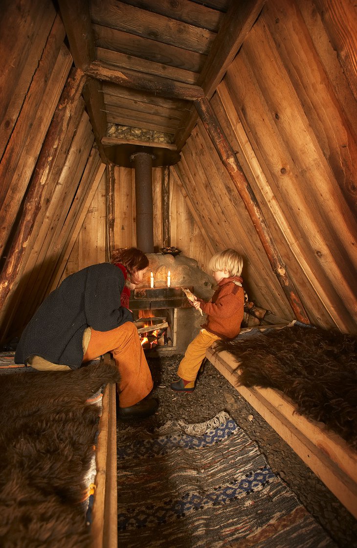 Mother and son at the firplace in the hut