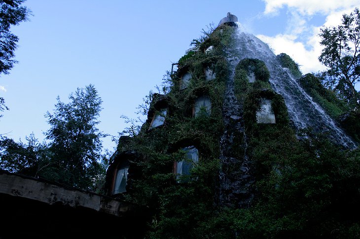 Wooden building with fountain coming from the top