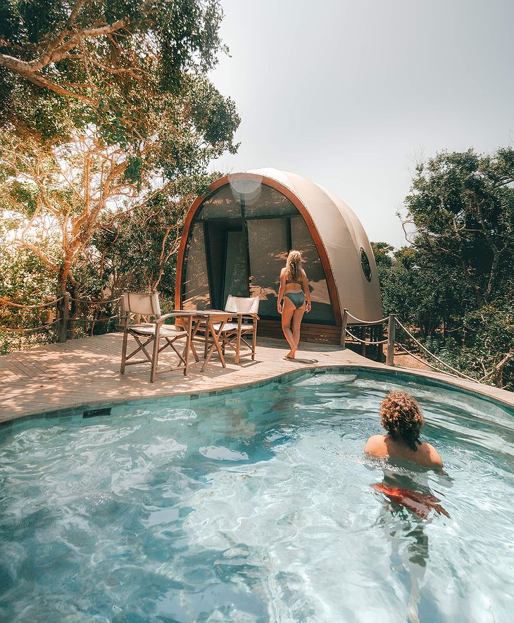 Wild Coast Tented Lodge cocoon tent with pool and a young couple.