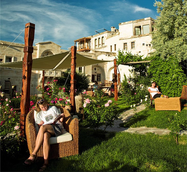 Kelebek Cave Hotel garden with relaxing people