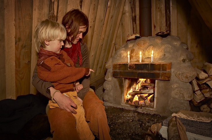 Mother and son at the firplace in the hut