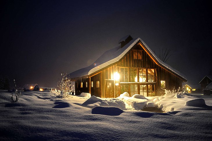 Lit up wooden cabin of Dunton Hot Springs in the winter