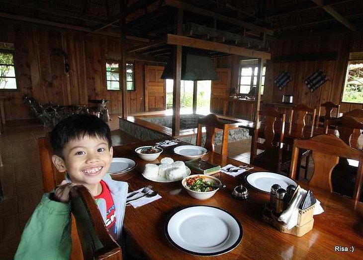 Native Village Inn Philippines restaurant with food and a local kid