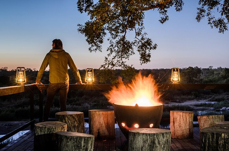 Singita Boulders Lodge fireplace on the terrace at night