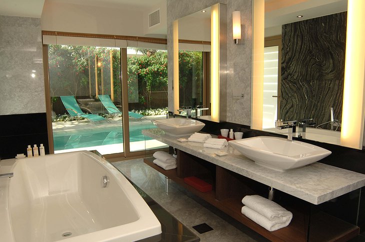 Desert Palm Resort Dubai bathroom with view on the pool