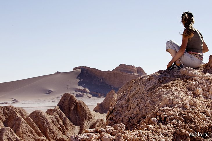 Girl sitting on a rock in the desert