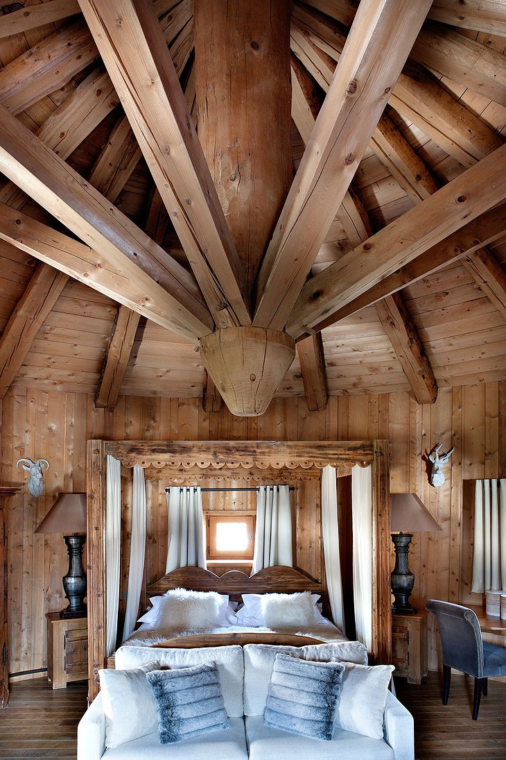 Les Fermes de Marie bedroom with high wooden ceiling