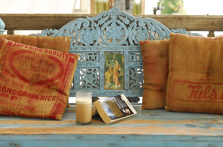 The Farm Jaipur wooden sofa with Hindu decoration