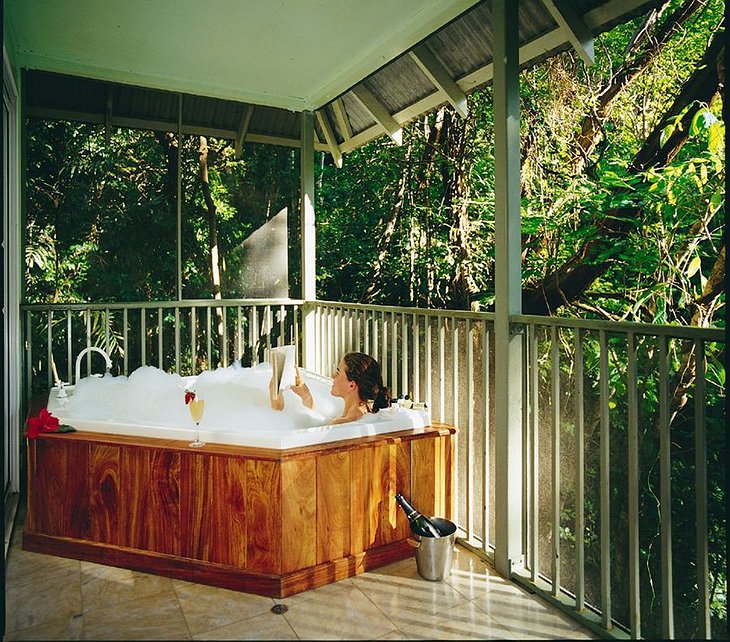 Girl in the jacuzzi with champagne and a book