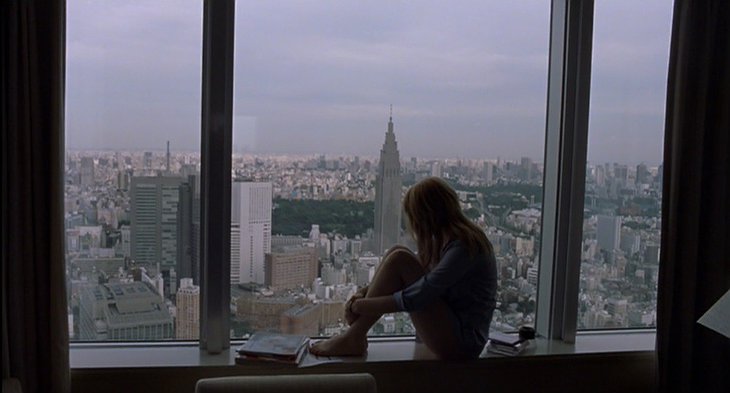 Charlotte (Scarlett Johansson) sitting in the window that overlooks Tokyo