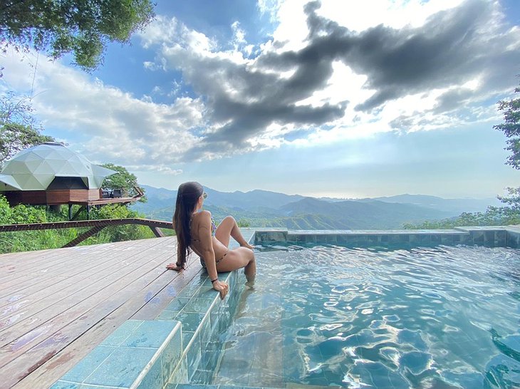 Girl Sitting At The Pool Overlooking The Sierra Nevada Mountain Range In Minca