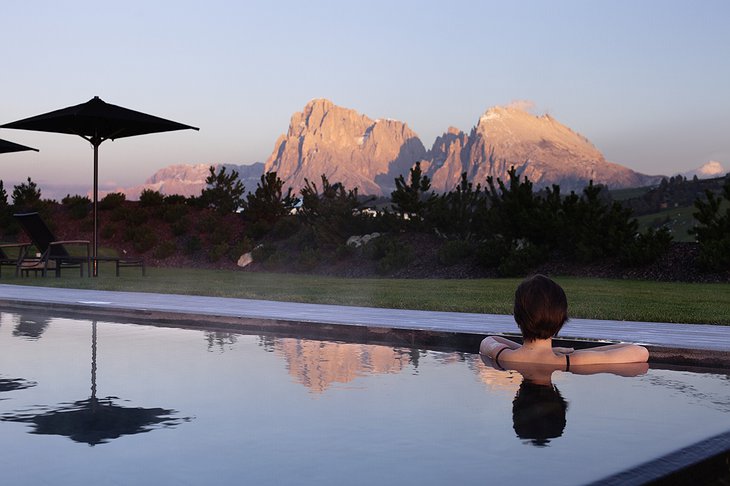 Alpina Dolomites hotel outdoor pool with a girl in it