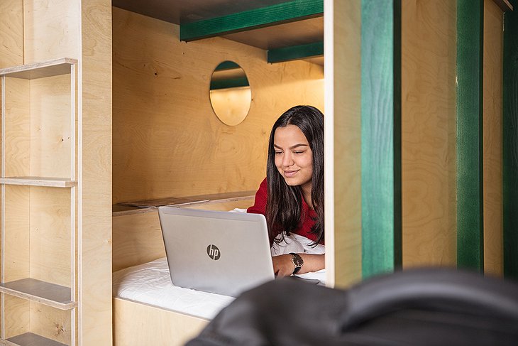 Green Marmot Capsule Hotel Capsule Girl With Laptop