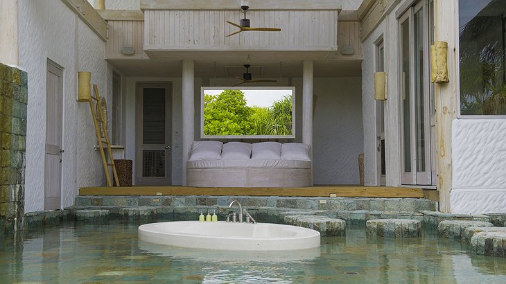Soneva Jani Maldives outdoor bathroom with bath tub in the water