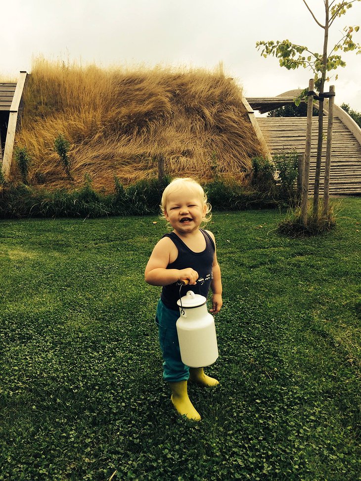 Small smiling kid helping on the farm