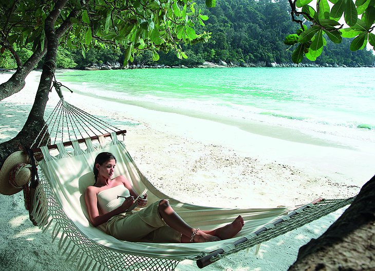 Girl in a hammock at a gorgeous beach