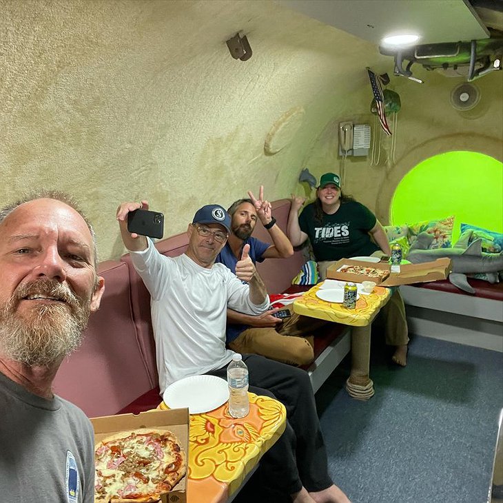 Jules' Undersea Lodge Eating Pizza