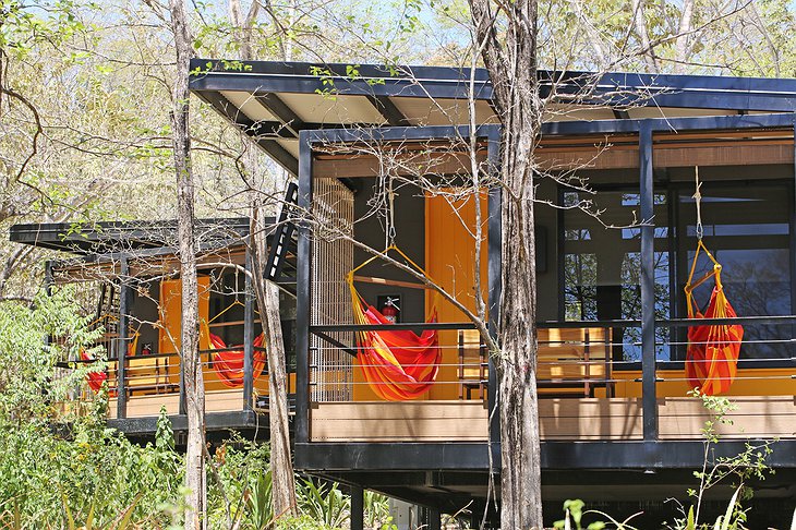 Rio Perdido lodge bungalow exterior with hammocks