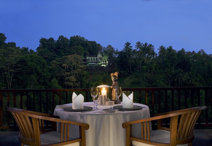 Candelit dinner with temple in background at Hanging Gardens Ubud