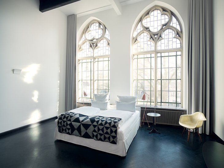 THE QVEST Salon Suite Bedroom with Large Gothic Windows