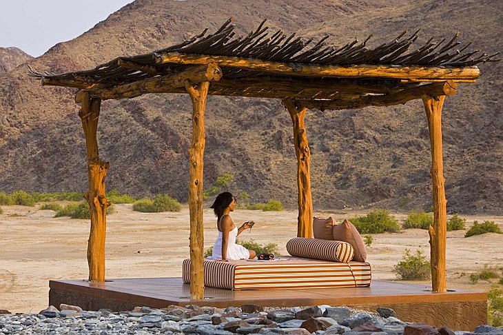 Okahirongo Elephant Lodge outdoor bed with nature surrounding it