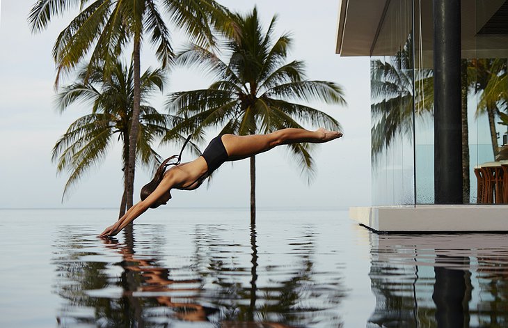 Model girl jumping to the pool